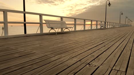 Long-drone-shot-from-down-pier-to-flight-between-the-lanterns-and-go-over-sea