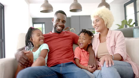 Diverse-African-American-family-sitting-together,-smiling