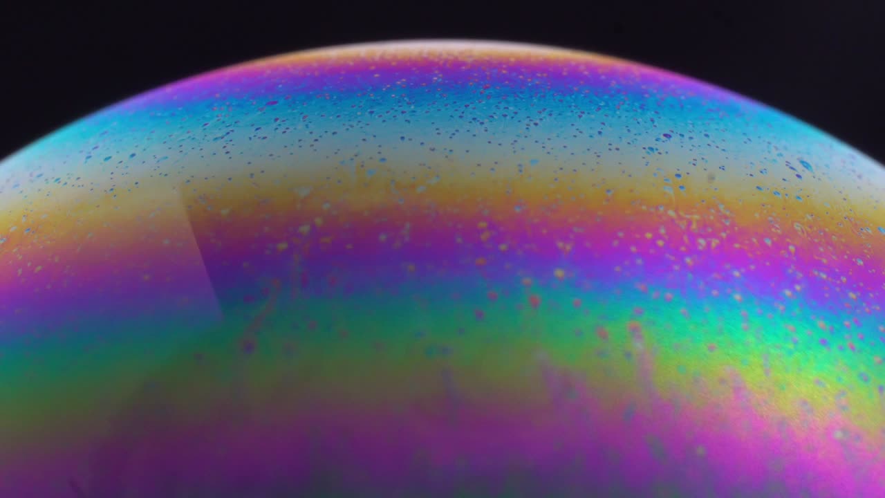 Abstract multicolor soap bubble texture, Model of Space or planets universe cosmic. Macro. Slow motion.
