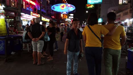 handheld scenes of the tourists are walking around khao san road at night time famous which each year tourists from many countries came to visit in bangkok, thailand.
