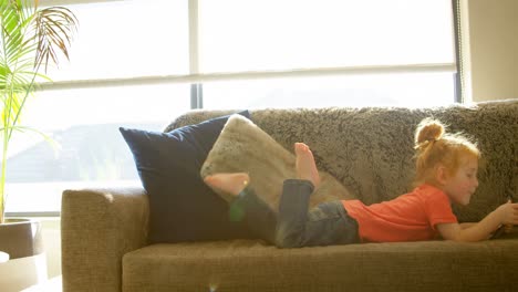Cute-little-boy-using-digital-tablet-in-living-room-at-home-4k