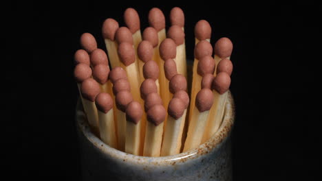 pot of safety matches rotating on black background