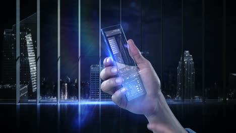 Hand-holding-futuristic-mobile-phone-against-digitally-generated-background