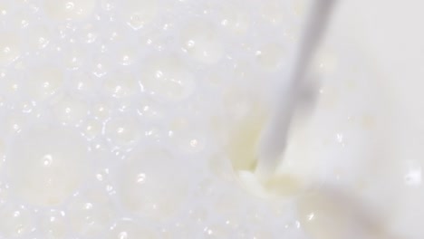 pouring milk splash with bubbles isolated on white pouring milk splash isolated on white background
