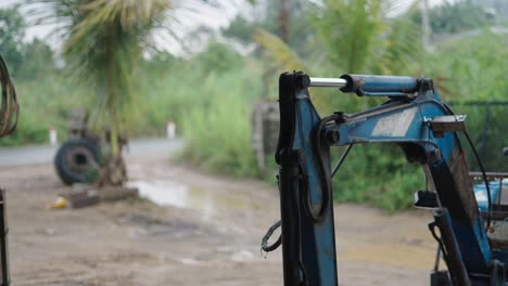 excavator arm in a rural setting