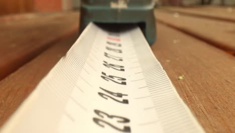 roll of measuring tape in motion macro