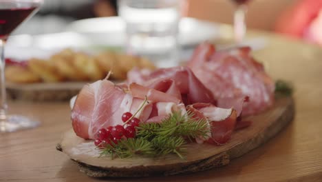 platter of various cold meats on a wooden tray