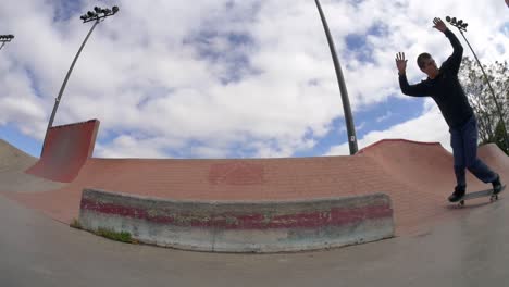 skater does a 360 on the ramp at the skatepark