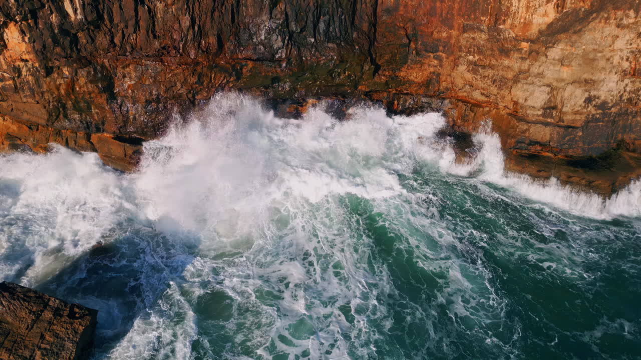 asombrosas olas marinas rompiendo en las rocas costeras en cámara lenta. océano poderoso aéreo.