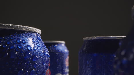 close up or macro shot of condensation droplets on takeaway cans of cold beer or soft drinks against black background 1