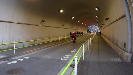 motorcyclist riding through a well-lit tunnel