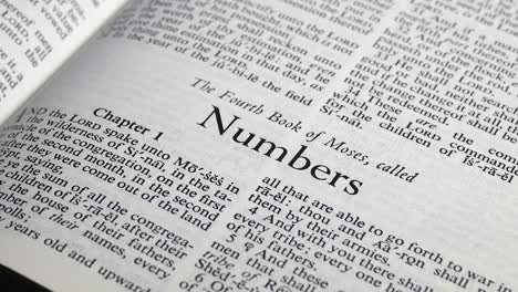 close up shot of bible turning to the book of numbers