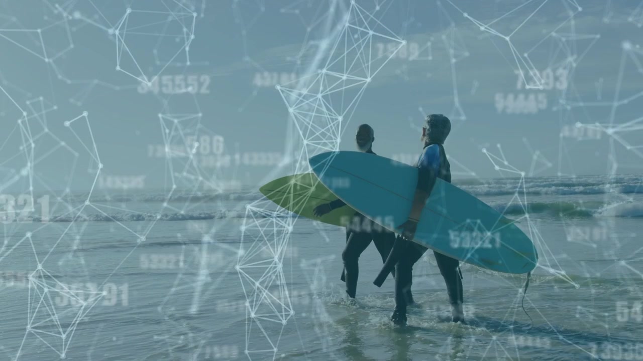 Two surfers walking into shore with boards spotting waves to catch, tech overlay tracking data