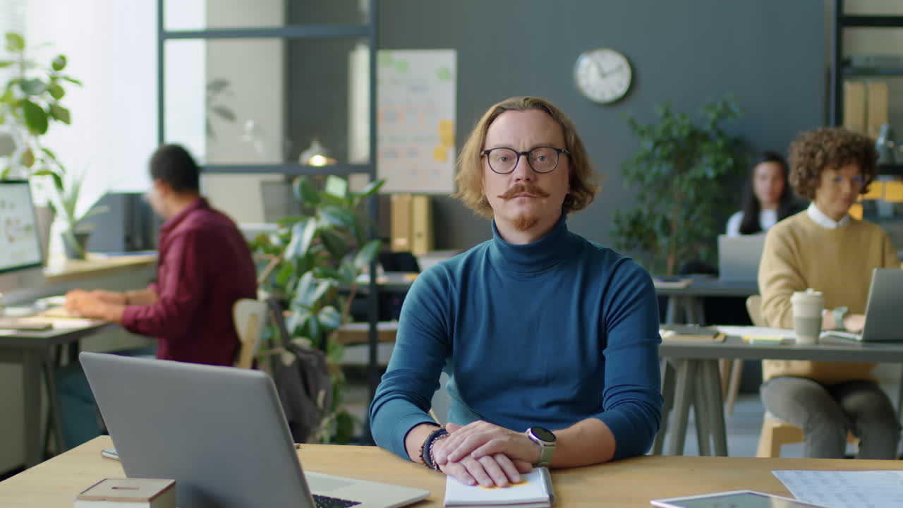 Portrait of Businessman during Workday in Office