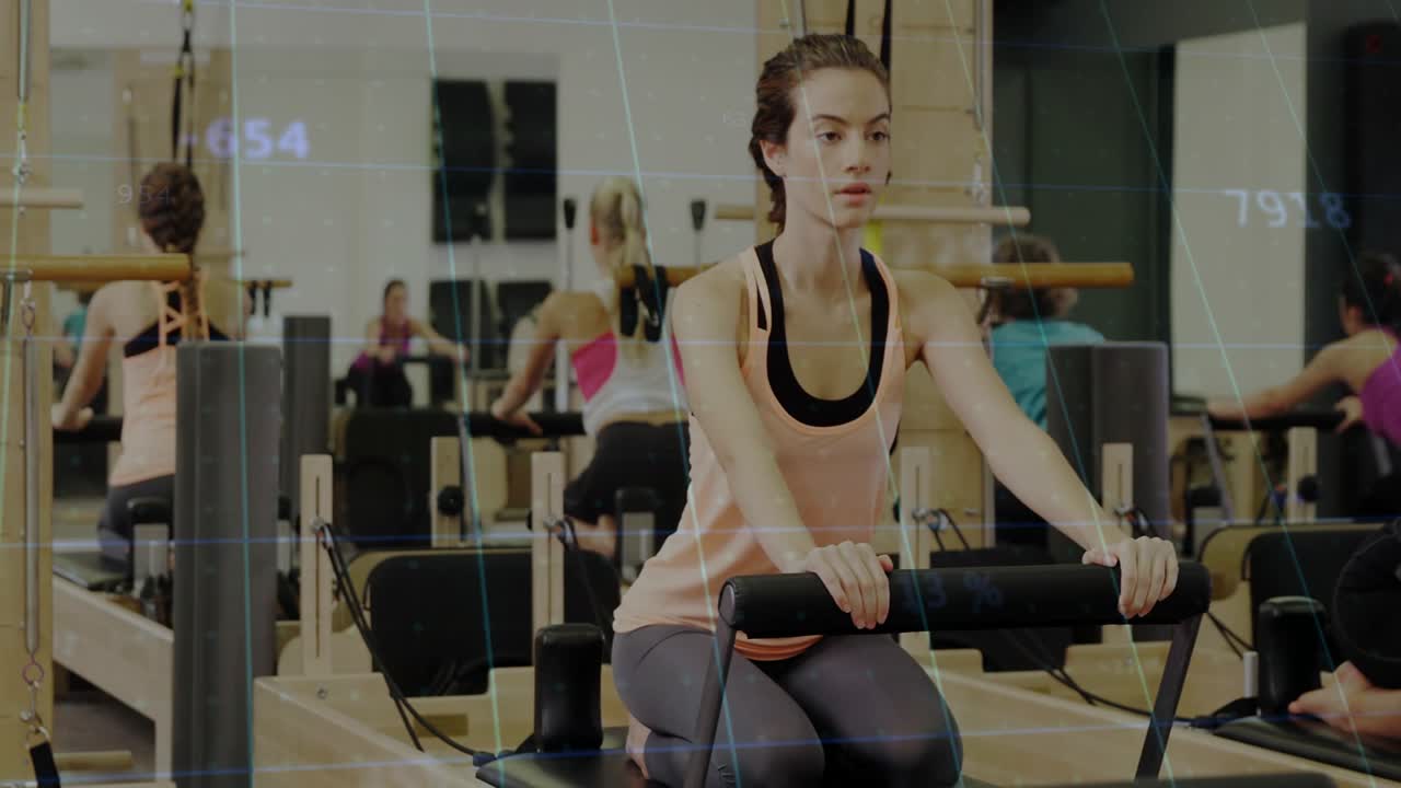 On instructor cue peach-tank woman pushing reformer, unfolding and aligning spine for Pilates form