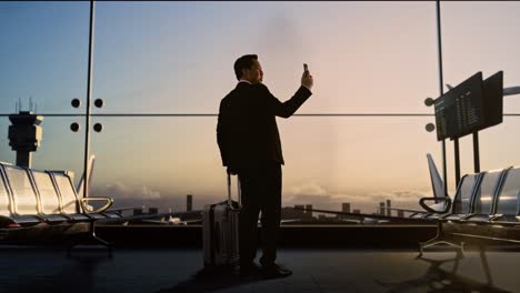businessman taking a selfie at the airport