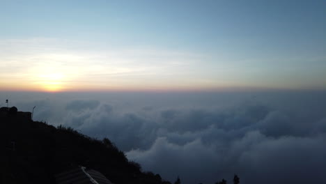 High-altitude-above-the-clouds-timelapse-of-early-morning-clouds-forming-in-the-mountains-at-sunrise,-Kodaikanal,-Tamil-Nadu