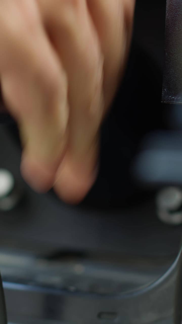 Vertical video Extreme close up of person opening vehicle inlet port of zero emissions EV car