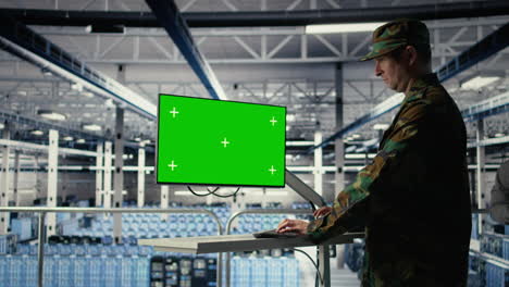 military data center professional using software on green screen mockup pc