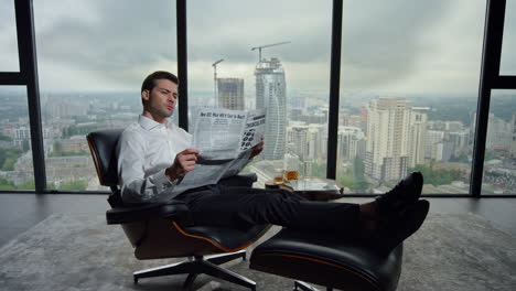 worker reading financial newspaper