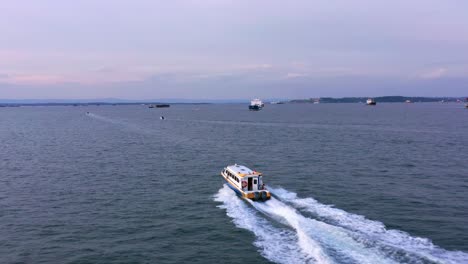 ferry motorboat with traces over sea near port of balikpapan in kalimantan, indonesia