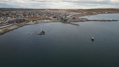 gulf montt in puerto natales chile, aerial above patagonian port city coastline, summer weather in travel south american destination