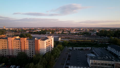 Ascending-aerial-shot-of-high-rise-district-in-Krakow-during-golden-hour,Poland