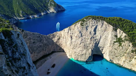 Playa-Navagio-En-Grecia-Con-Un-Naufragio,-Agua-Azul-Y-Acantilados-Imponentes-Vistos-Desde-Arriba