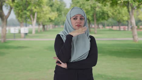 disturbed muslim woman disgusted by bad smell in park