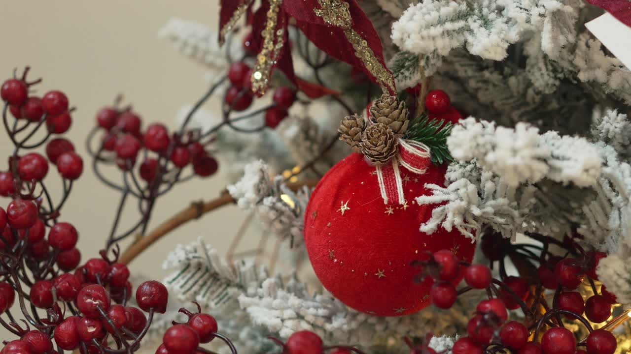 Close-up of a Red Christmas Ornament on a Snowy Christmas Tree