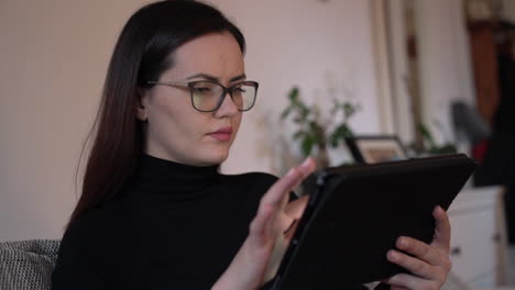 Handheld-portrait-of-a-serious-young-woman-using-a-tablet