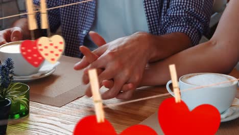 close up of a couple holding hand at cafe for valentine day