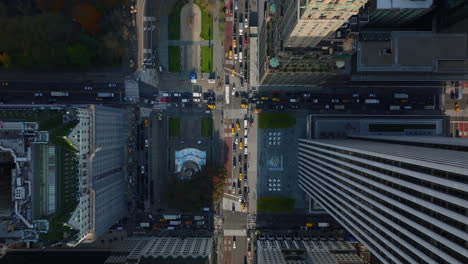 Aerial-birds-eye-overhead-top-down-panning-view-of-busy-streets-at-Pulitzer-and-Grand-Army-Plaza.-Manhattan,-New-York-City,-USA