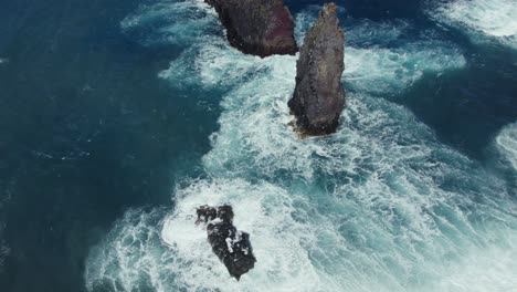 dramatic ocean waves crashing against rocky coastline