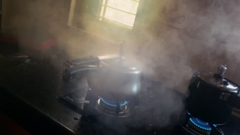 whistle blows and steam rushes out as food gets prepared