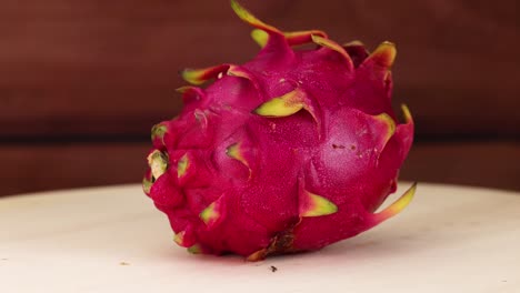 dragon fruit rotates on a wooden table