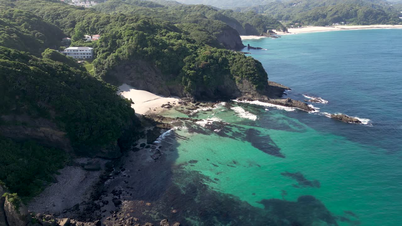 Slow dolly drone flight, flying over turquoise waters with tall cliffs