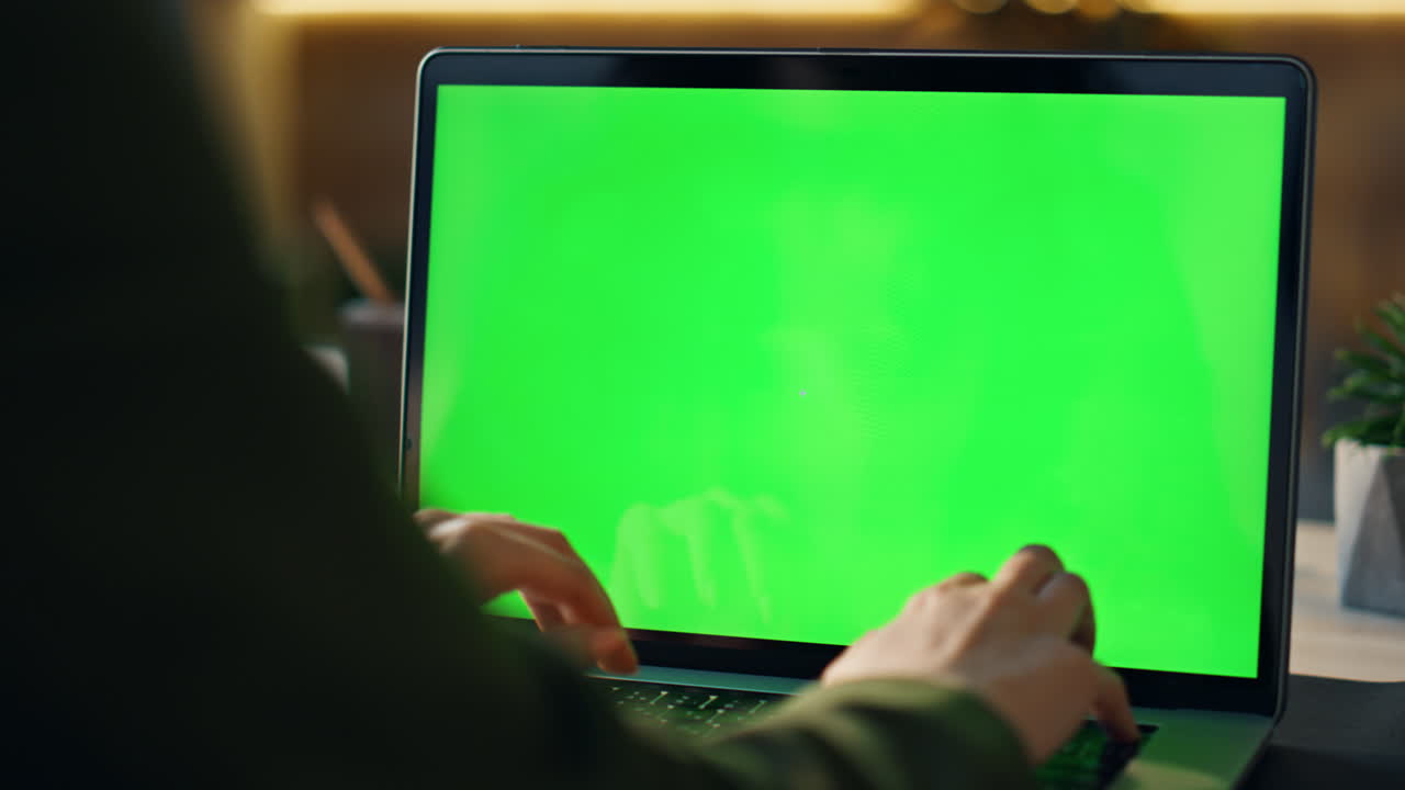 Hands typing greenscreen laptop at office closeup. Freelancer working chroma key