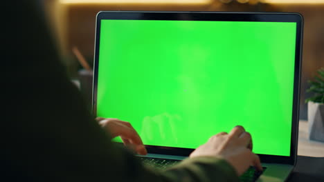 hands typing greenscreen laptop at office closeup. freelancer working chroma key
