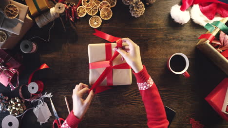 person wrapping a christmas gift