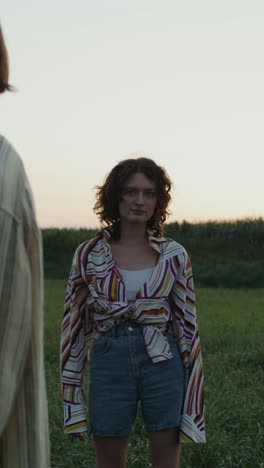 woman in field at sunset