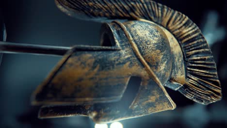 A-vertical-close-up-macro-shot-of-a-spartan-face-design,-warrior-metal-bronze-helmet,-on-a-360-rotating-stand,-studio-lighting,-Full-HD-video,-Slow-Motion-120-fps