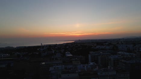 scenic aerial view of sunset with a view on the atlantic ocean and the urban city of lisbon, portugal