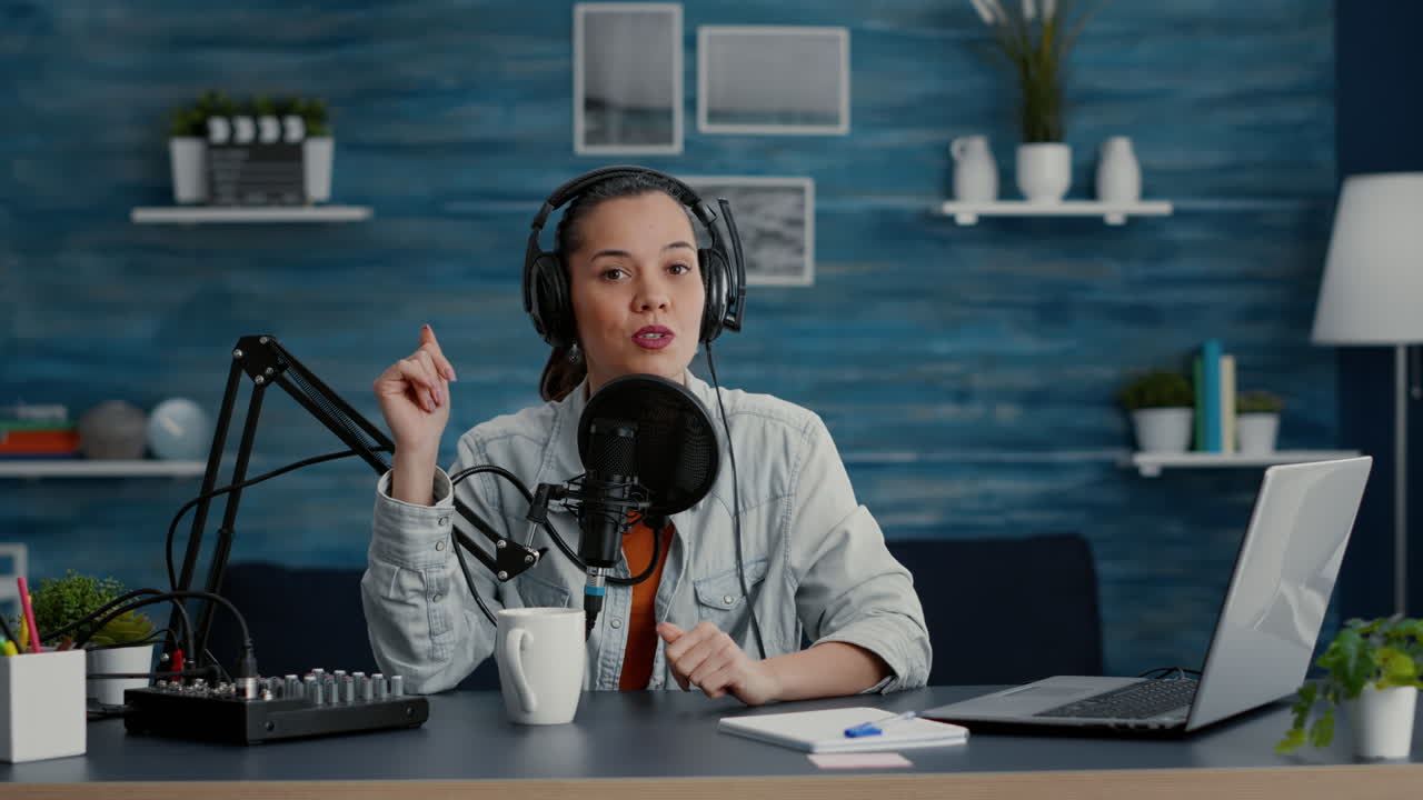 Attractive digital content creator checking microphone while recording daily vlog