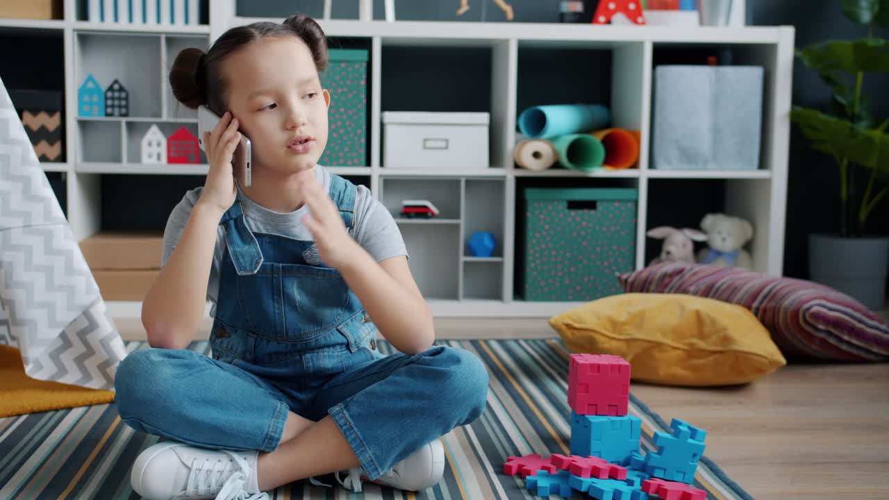 Girl Talking on Phone and Playing with Toys