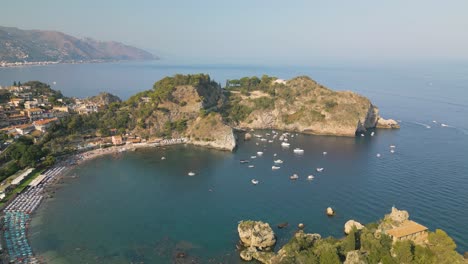 aerial pullback reveals beautiful isola bella, sicily, italy