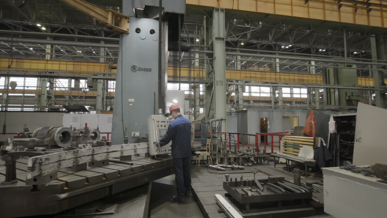Factory Worker Operating a Large Machine