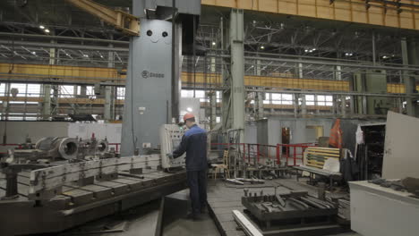 factory worker operating a large machine