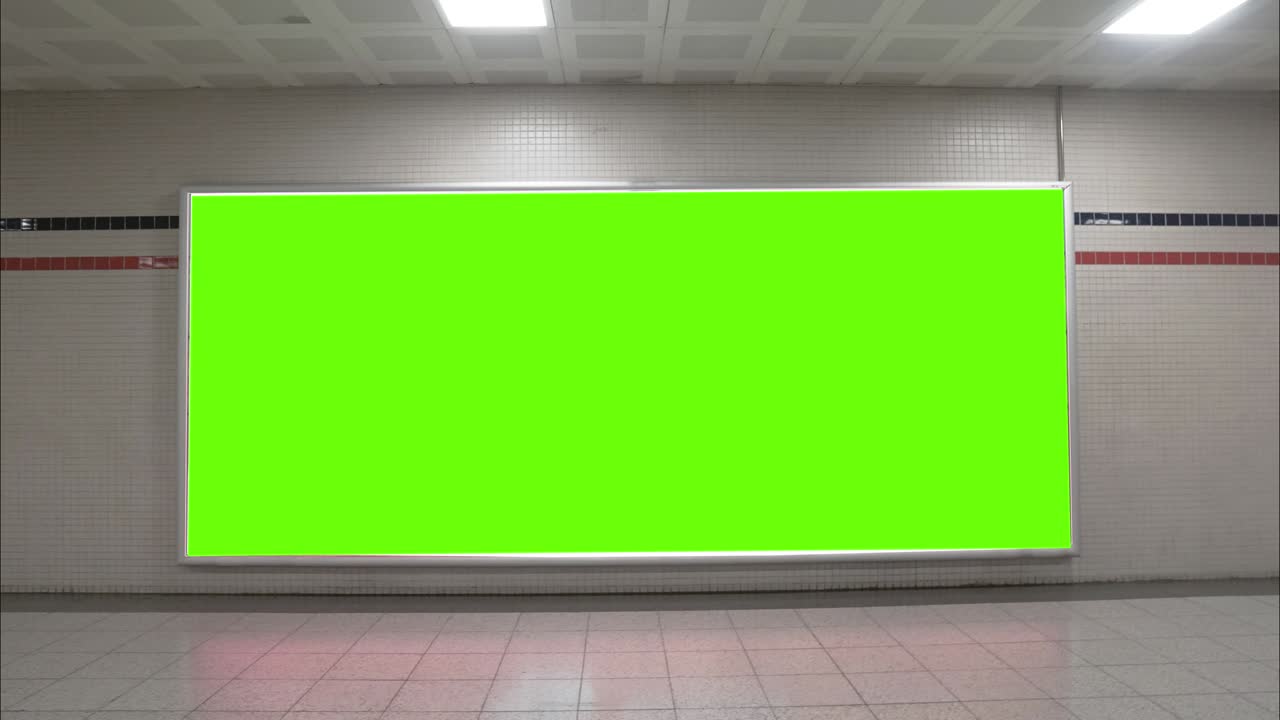 Big green screen billboard on airport wall. Widescreen chroma key mock up subway frame for advertisement.