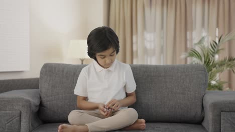 Indian-boy-counting-money-coins